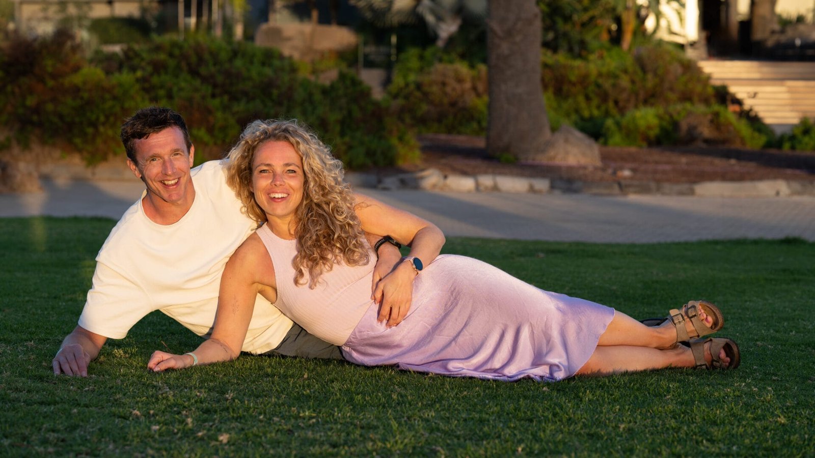 Maternity shoot couple on green lawn Gran Canaria