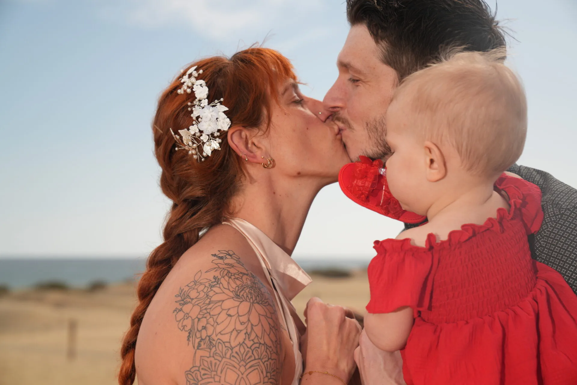 Family kiss with child on beach Gran Canaria