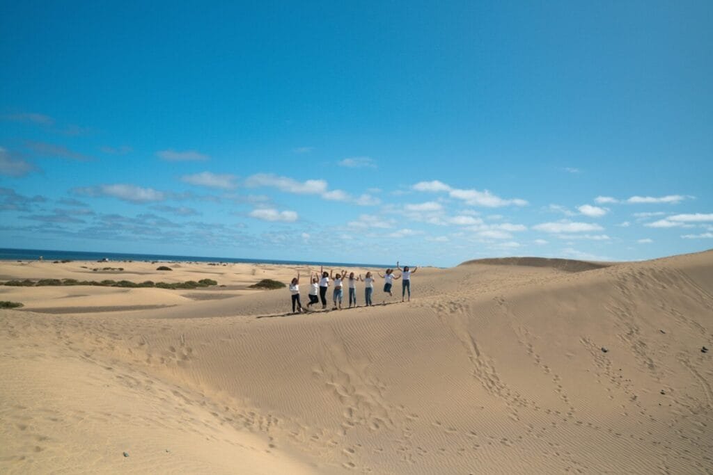 Friends having fun during a photoshoot at maspalomas dunes