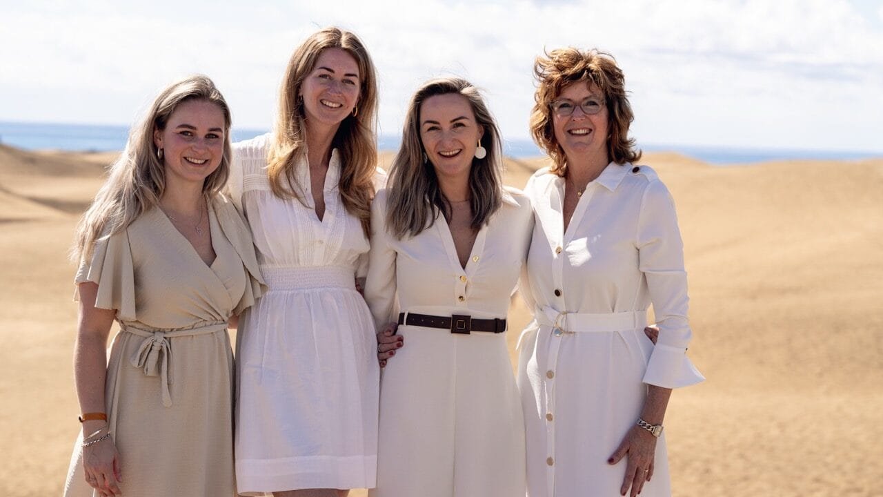 Four women friends in white dresses on the dunes Gran Canaria