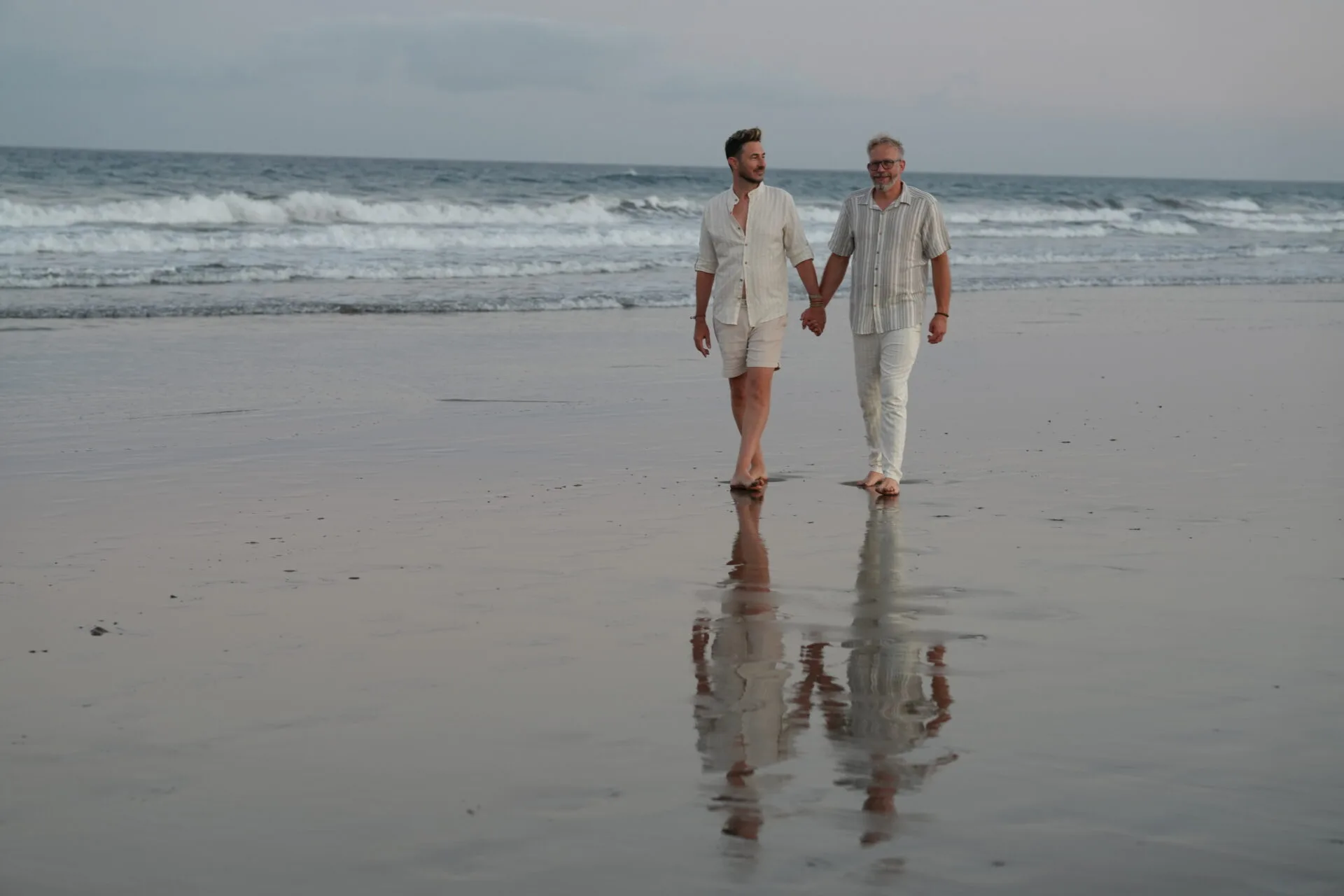 Same-sex couple walking hand in hand on the beach Gran Canaria