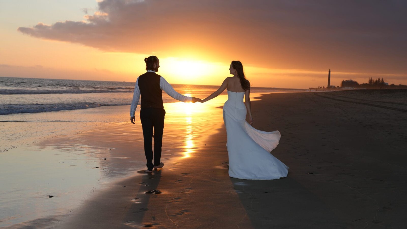 Wedding couple silhouette at sunset Gran Canaria lighthouse