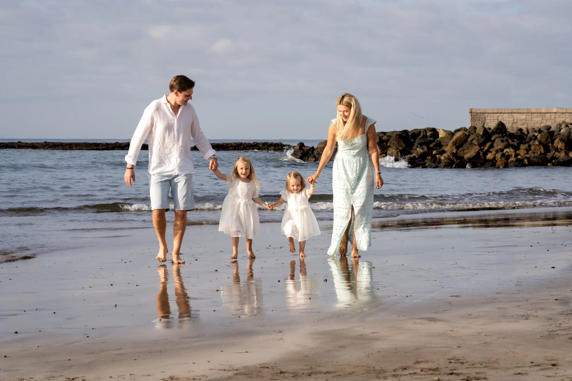 Family of four walking on the beach Gran Canaria
