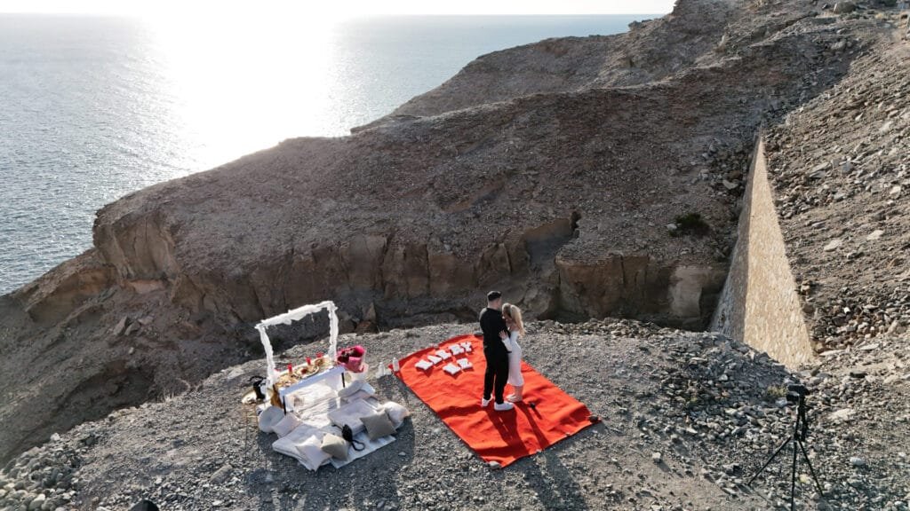 Proposal photoshoot with picnic on hilltop near Mogan