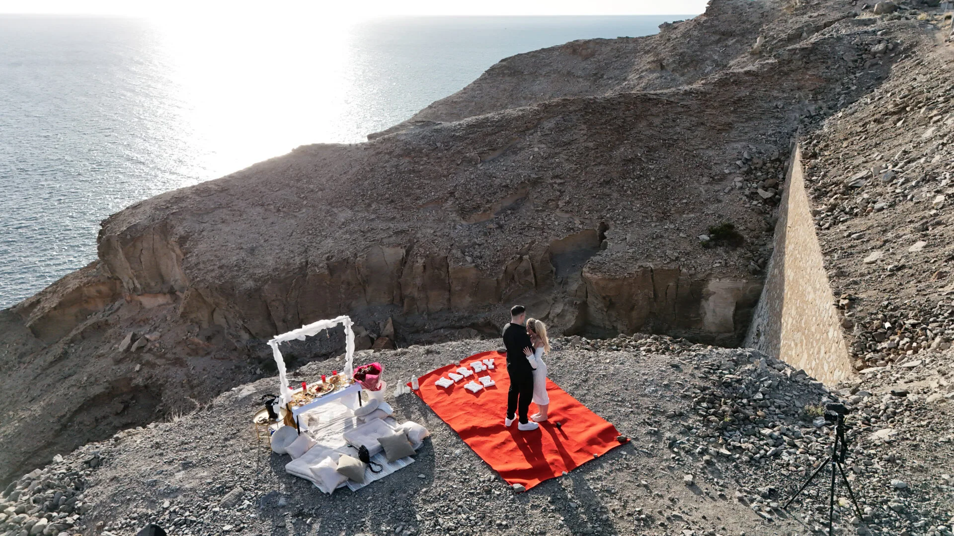 Aerial drone view luxury proposal setup on cliff above the sea Mogan Gran Canaria