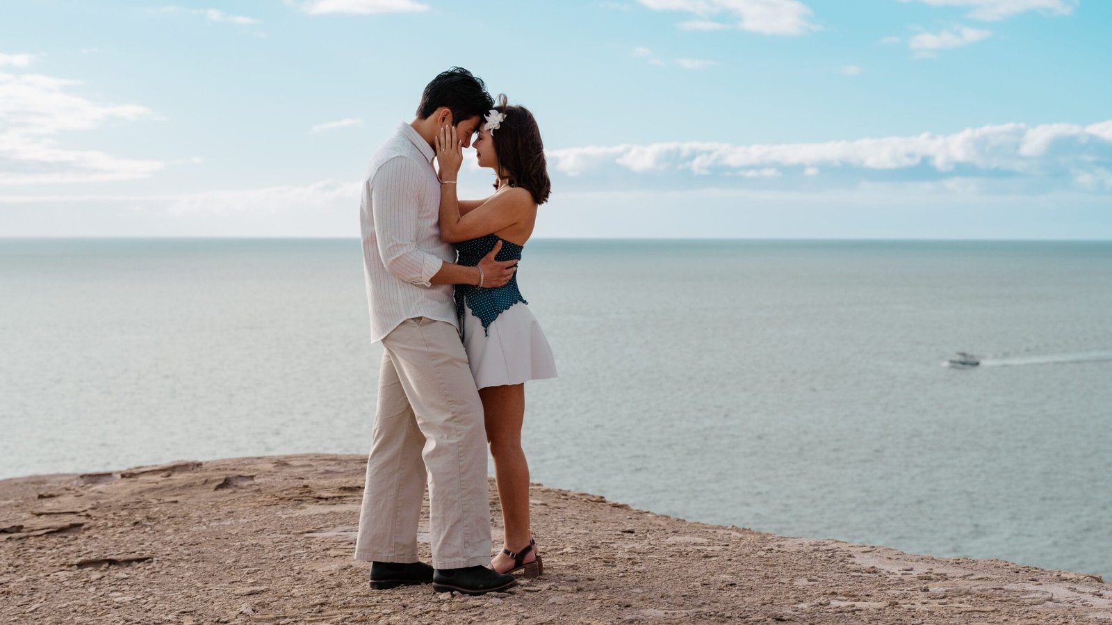 Romantic couple kissing on cliff above the ocean Gran Canaria