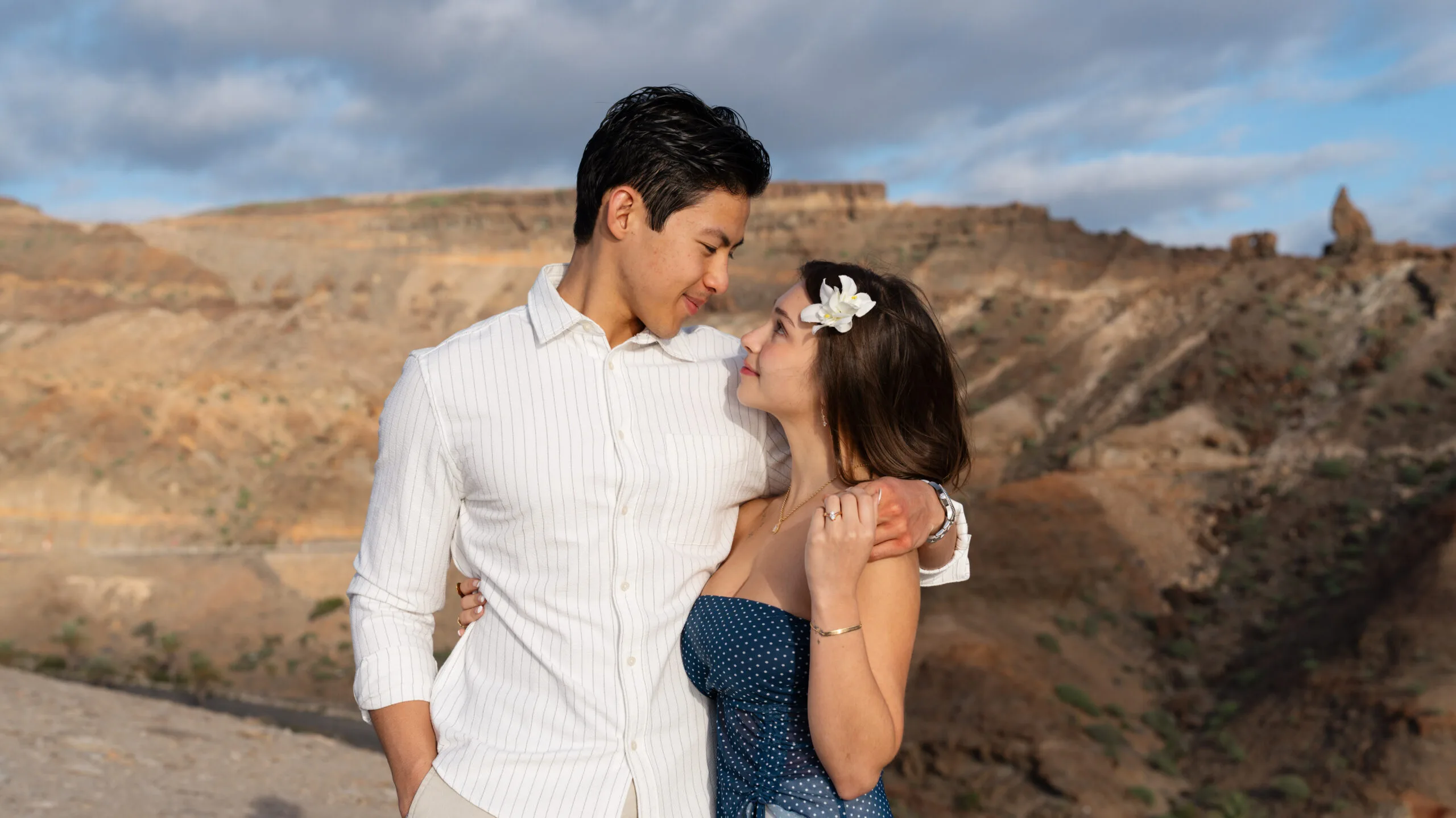 Couple embracing on volcanic rock formations, Puerto Rico Gran Canaria