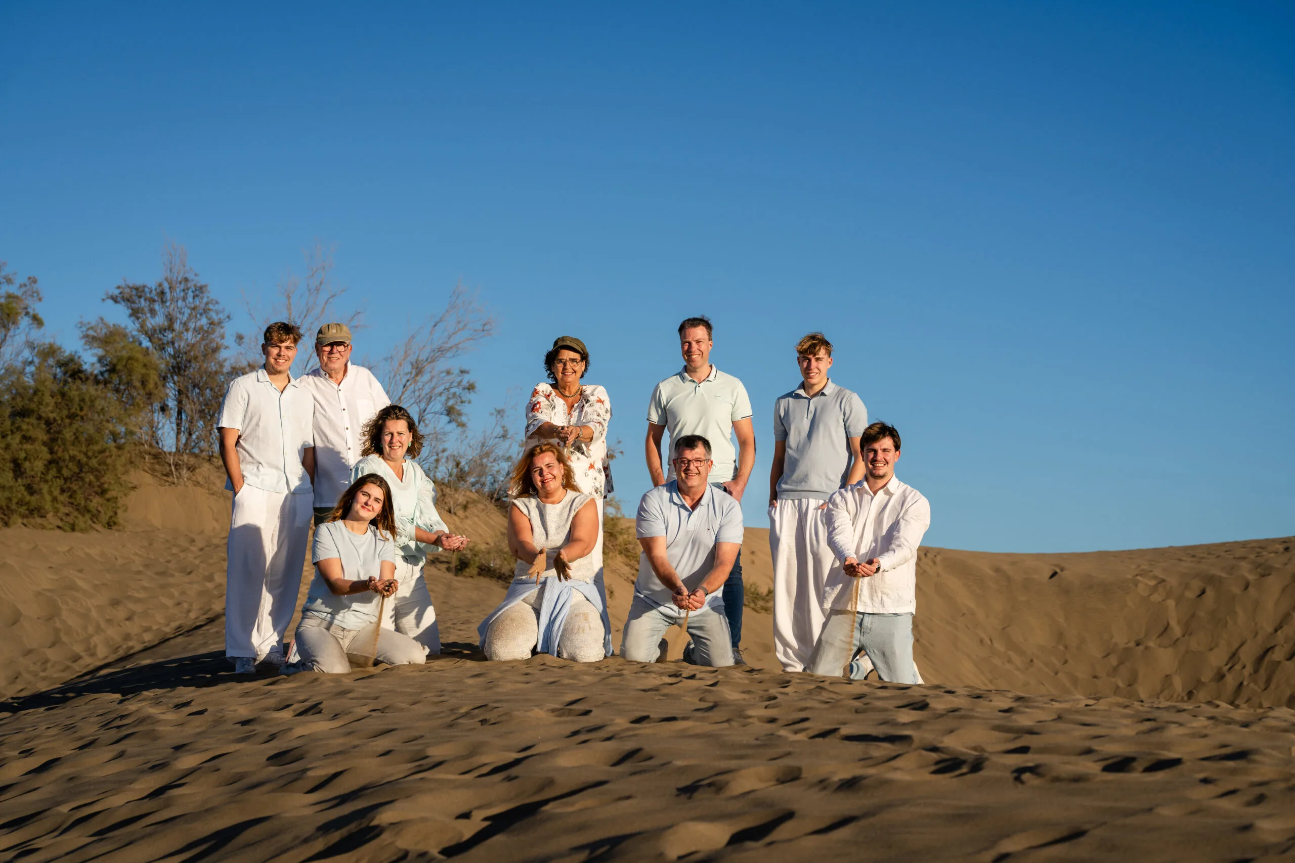 Large family group in white on Maspalomas Dunes