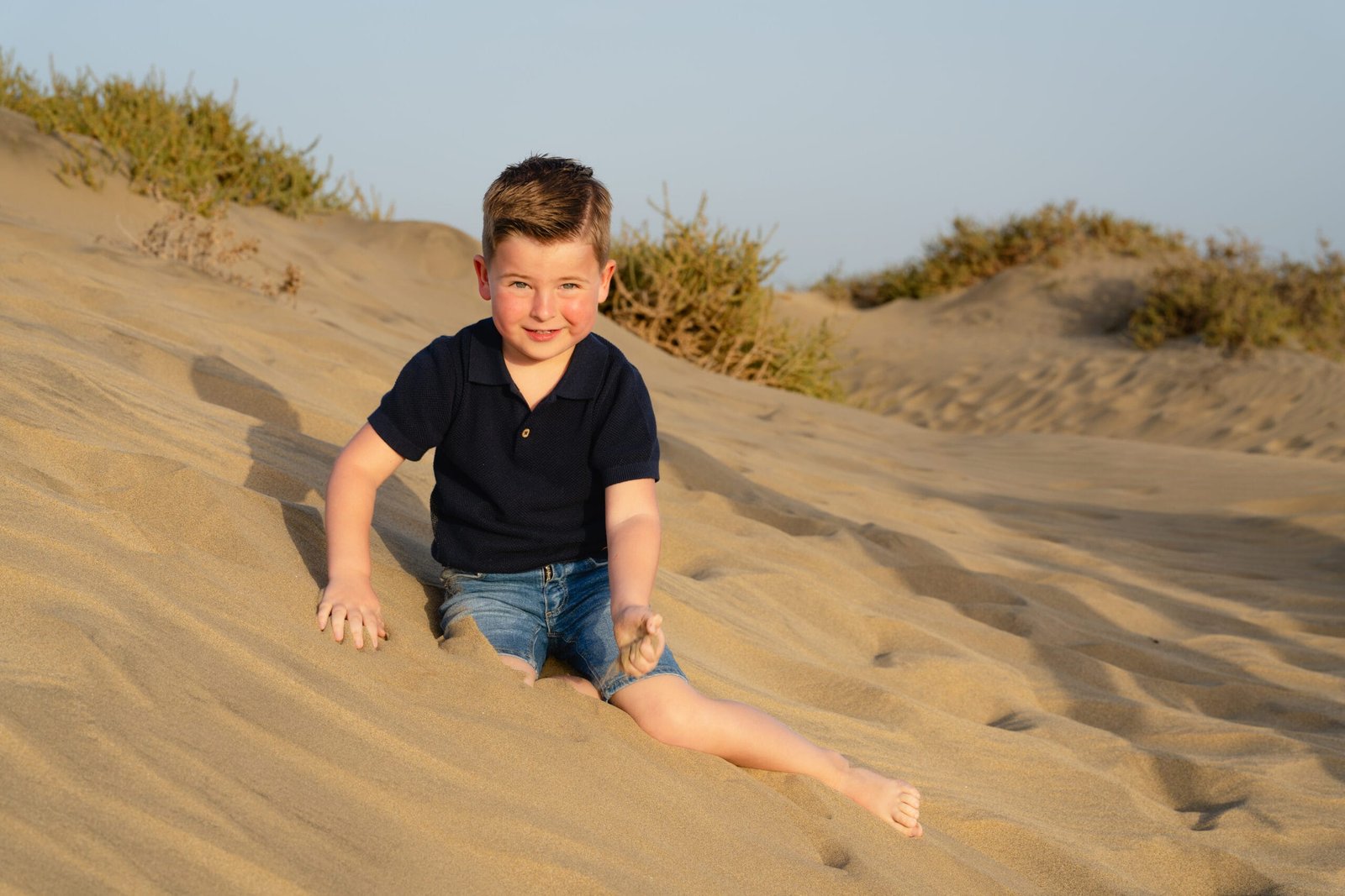 Boy in the dunes at golden hour Gran Canaria