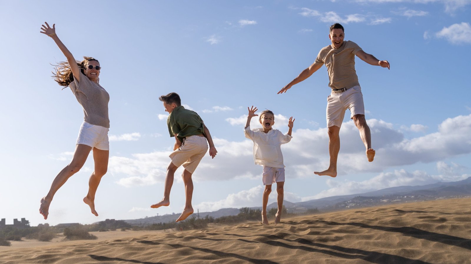 Family jumping on the beach Gran Canaria