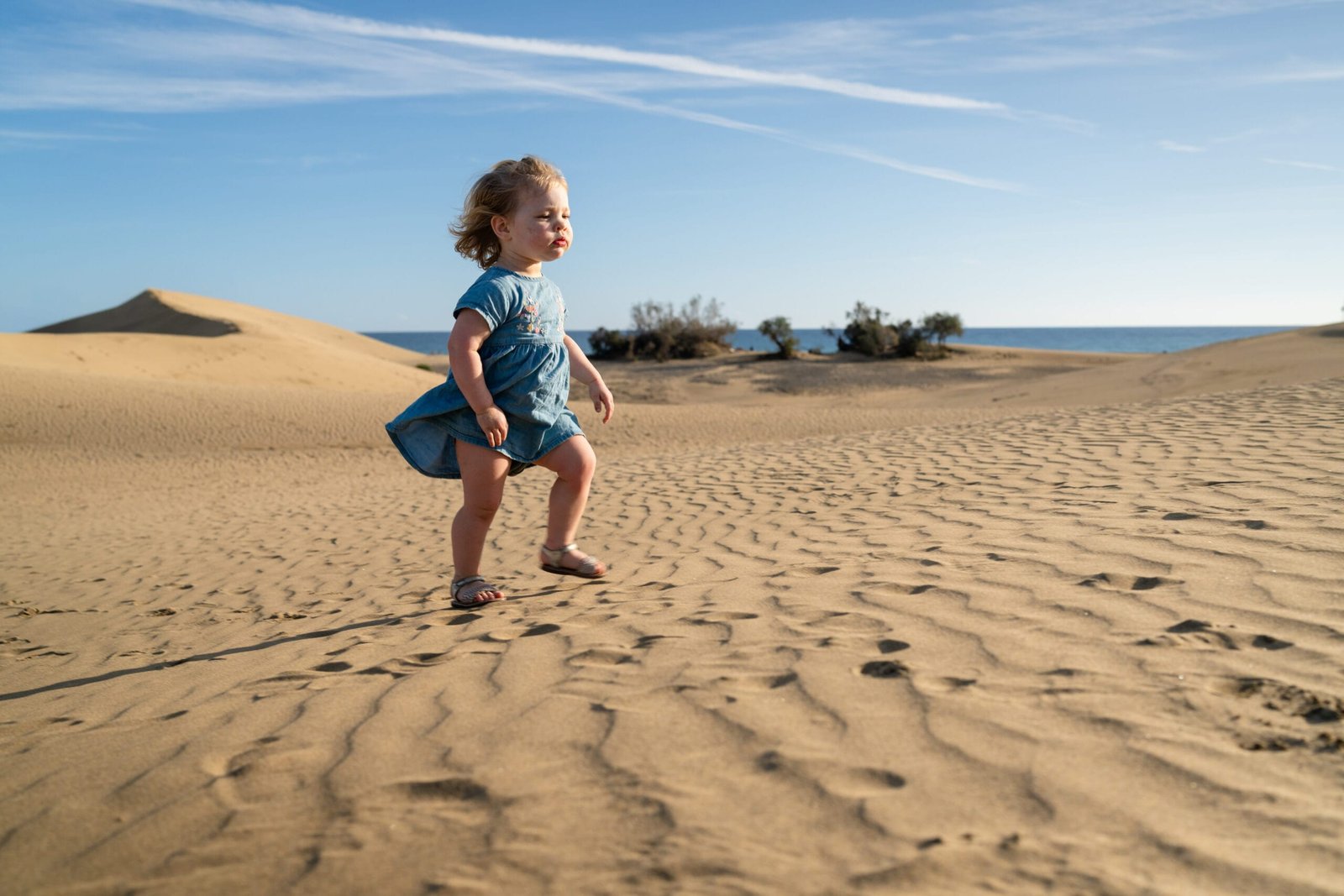 Toddler walking through Maspalomas Dunes