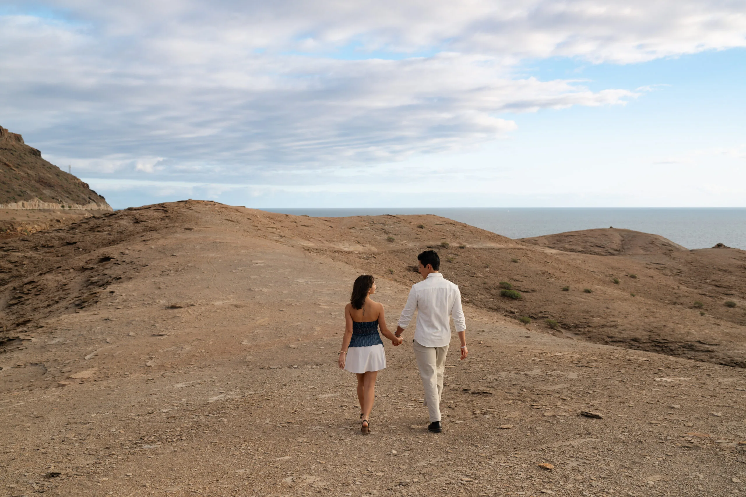 Couple walking hand in hand towards the Atlantic coastline, Puerto Rico