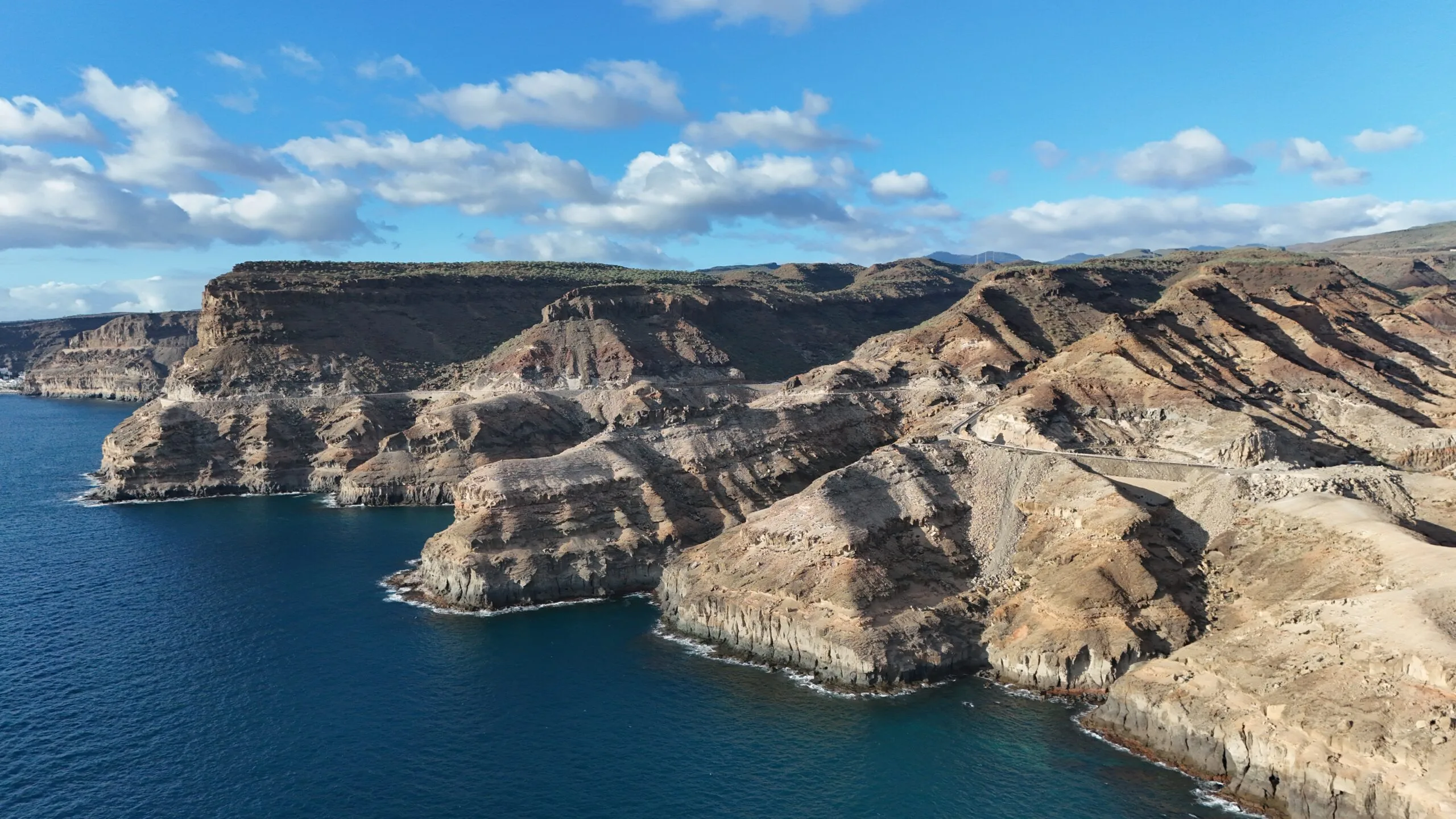 Aerial drone view of the dramatic cliffs and coastal road at Puerto Rico, Gran Canaria