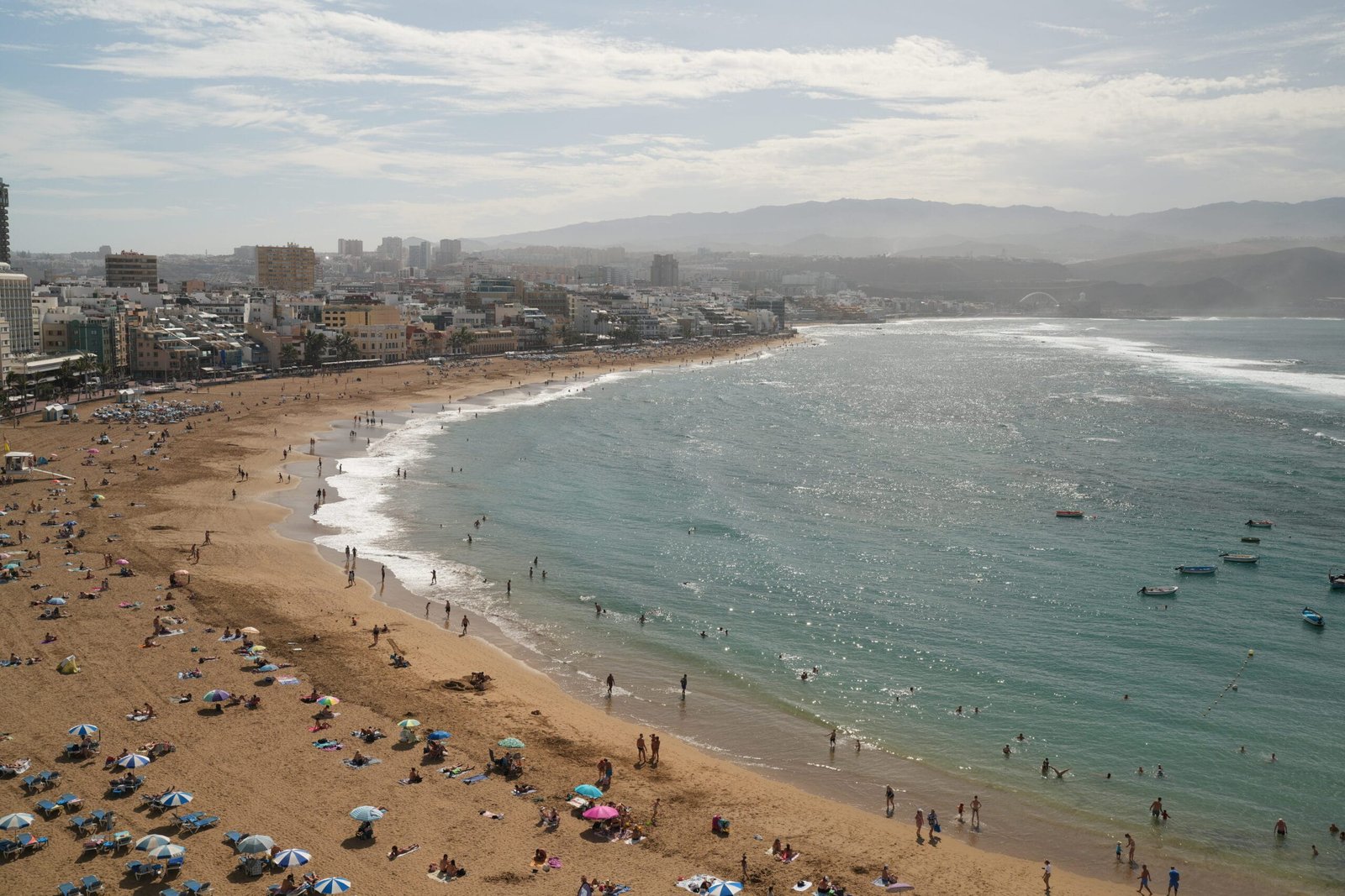 Las Canteras Beach Las Palmas de Gran Canaria turquoise water boats cityscape