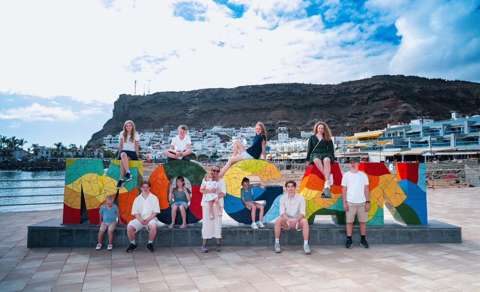 Family group photoshoot Puerto de Mogán Gran Canaria sculpture harbour mountain view