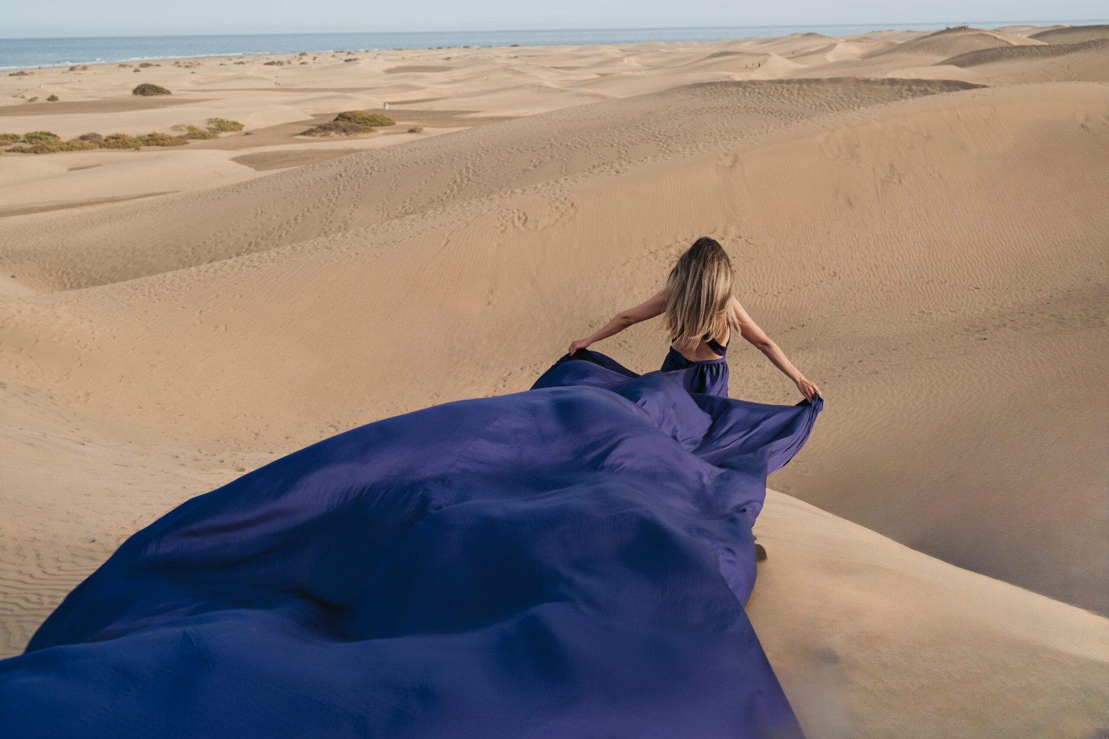 Flying dress photoshoot with five metre long gown on the dunes Gran Canaria