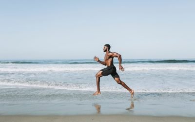 Fit man running at the beach